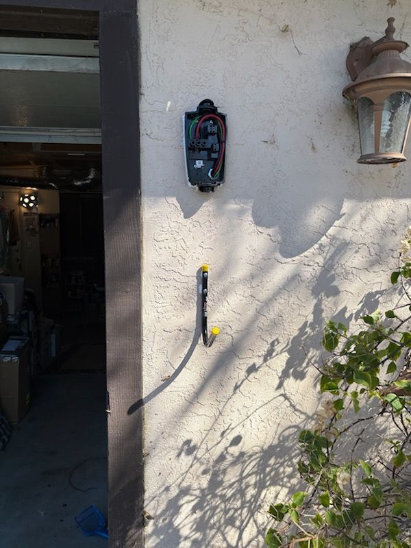 Outdoor EV charger mounted on a home exterior