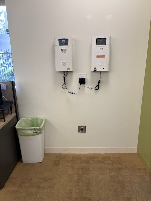 Two wall-mounted EV chargers in a finished tenant space