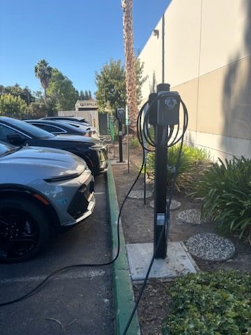 Row of EV charging stations with cars charging